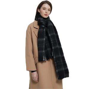 Classic black and grey checkered loop yarn scarf paired with a stylish camel wool coat