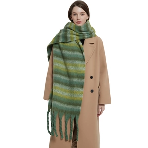 Thick winter scarf with green and yellow gradient stripes and long chunky tassels