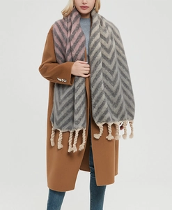 Detailed texture of thick herringbone scarf with chunky twisted tassels in grey and pink