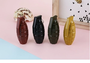 Detail of creative grenade-shaped retractable pens in four colors with metal ring clips