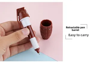 Close-up of hand holding creative grenade-shaped retractable ballpoint pen with ring