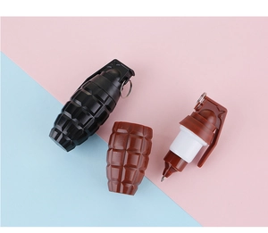 Detail of grenade-shaped novelty pens featuring a retractable nib and metal key ring