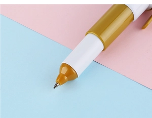Close-up of a modern white and gold creative ballpoint pen with a sleek metal tip
