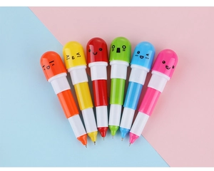 Détail de six stylos capsules rétractables colorés avec des visages d'emoji mignons