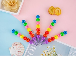 Detail of five stackable smiling face pencils with colorful modules on artistic background
