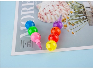 Close-up of stackable smiley face wax crayons with 7 vibrant colors in a creative design