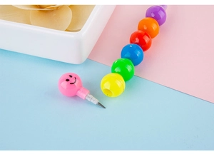 Macro view of stackable smiley face rainbow pencil with colorful segmented sections