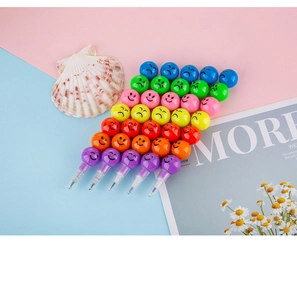 Detail of multi-color stackable pencils with cartoon faces and rainbow sections