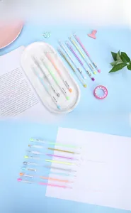 Macro shot of colorful glitter gel pens set with clear barrels on a blue desk