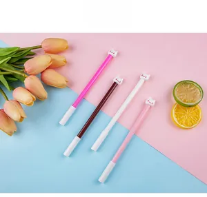 Close-up of four cute cat-topped gel pens in various colors on a pastel background