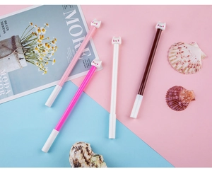 Set of four cute cartoon cat gel pens in pink and white displayed on a pastel background