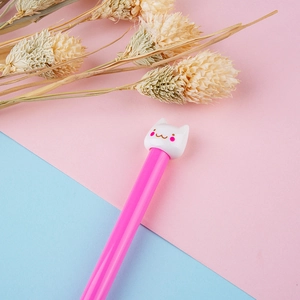 Cute pink cat head gel pen with cartoon cap on a minimalist pastel floral background
