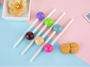 Detailed top view of six lollipop shaped pens in various candy colors on a pastel background