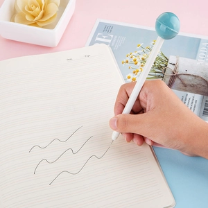 Lollipop shaped 0.5mm black gel pen in hand writing on paper with pastel background