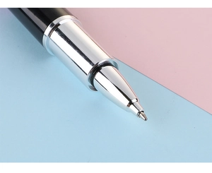 Macro shot of fine metal pen nib and black barrel connection with lipstick style design