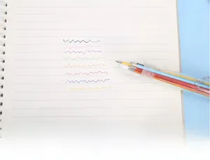 Close-up of 8-color ballpoint pen writing samples on white lined notebook paper
