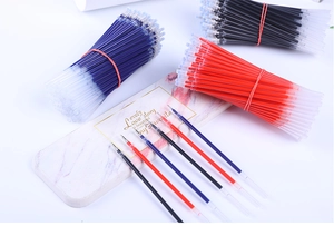 Bundled 0.5mm gel pen refills in black, blue, and red with protective tips on marble background