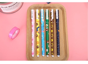Close-up of 6 colorful cartoon pens with floral and animal prints on a wooden tray