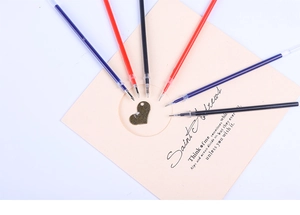 Macro shot of 0.5mm needle tip refills in black, red, and blue ink colors
