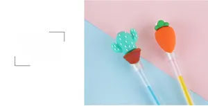 Détail macro de stylos gel transparents avec capuchons créatifs en forme de carotte et cactus