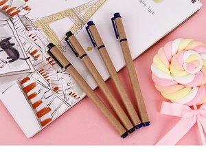 Eco-friendly kraft paper gel pens set on pink background with stationery props
