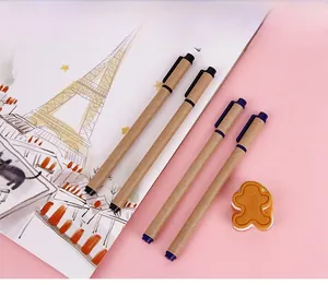 Eco-friendly kraft paper pens and small eraser on a pink notebook background