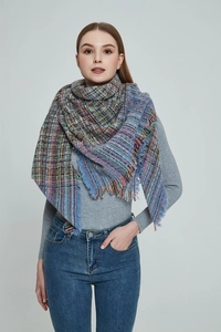 Detail of colorful plaid scarf with vintage tweed texture and fringe tassels for autumn