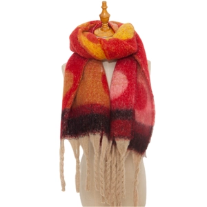 Detailed view of heavy knit gradient scarf in red orange yellow with thick twisted tassels