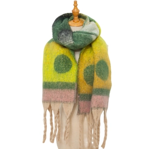 Detail of colorful knitted scarf with large green polka dots and chunky braided fringe