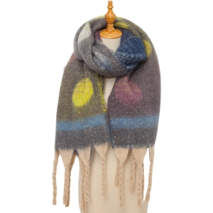 Close-up of thick gradient scarf featuring large colorful polka dots and woven tassels
