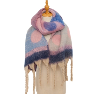 Detail of colorful polka dot knit scarf with long tassels on a display mannequin