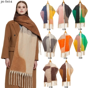 Detailed grid of geometric thick fringe shawls in eight diverse color combinations