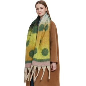 Thick colorful mohair-style shawl with polka dots and chunky tassels on model