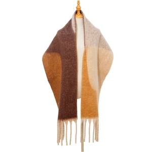 Close-up of thick geometric knit shawl with fringed edges and earthy tone patchwork
