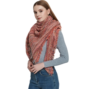 Thick colorful textured scarf with orange tones, fringed edges and chunky knit weave