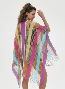 Detail of colorful rainbow striped knit shawl with openwork weave and fringe trim