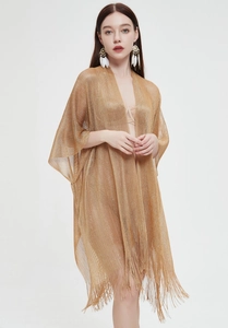 Detail of champagne gold mesh shawl with lurex metallic fibers and long fringe trim
