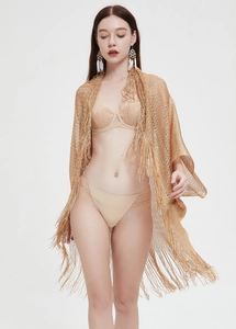 Detail of knit gold metallic shrug with long hanging tassels and openwork texture