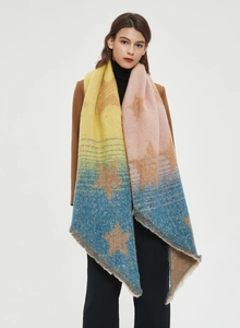 Close-up of star pattern knit shawl with gradient yellow, pink and blue colors