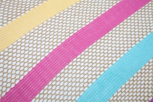 Close-up of lightweight rainbow striped mesh knit shawl with detailed openwork texture