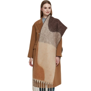 Thick geometric shawl scarf with tassels and colorful patchwork in warm autumn tones