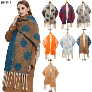 Thick winter knit scarf with large polka dots and tassels in various contrast colors