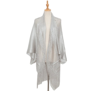 Detail view of silver metallic knit shawl featuring delicate fringe and shimmering texture