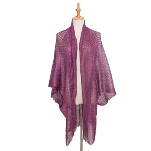 Detail of purple knitted shawl with metallic shimmer yarn and long fringe tassels