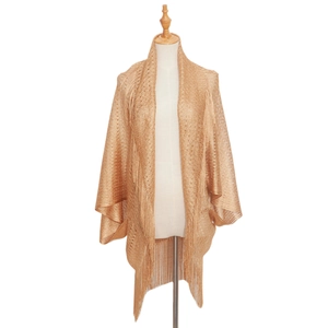 Detail of gold hollow knit shawl featuring long elegant fringes on the hemline