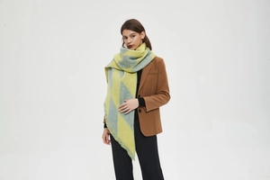 Macro detail of thick yellow and blue striped shawl with soft cashmere texture and fringe