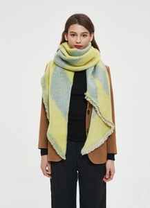 Detail of yellow and blue oversized plaid shawl with soft fringe and thick texture