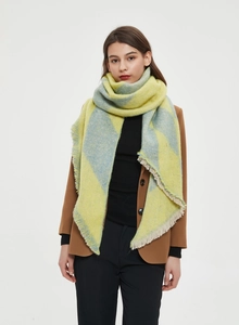 Detailed view of yellow and blue argyle pattern shawl with soft fringe edges