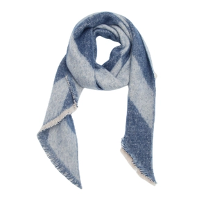 Detail of blue and white geometric knit shawl with fine fringe edges for winter