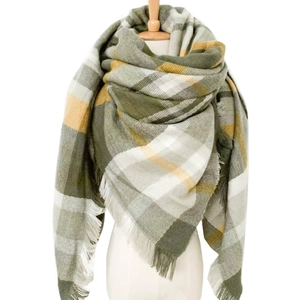 Detailed view of the olive green and yellow plaid scarf with soft fringe edges